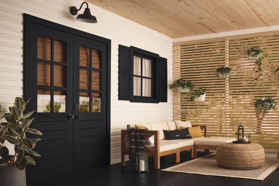 Enclosed porch living area, white siding, True Black trim and floor.