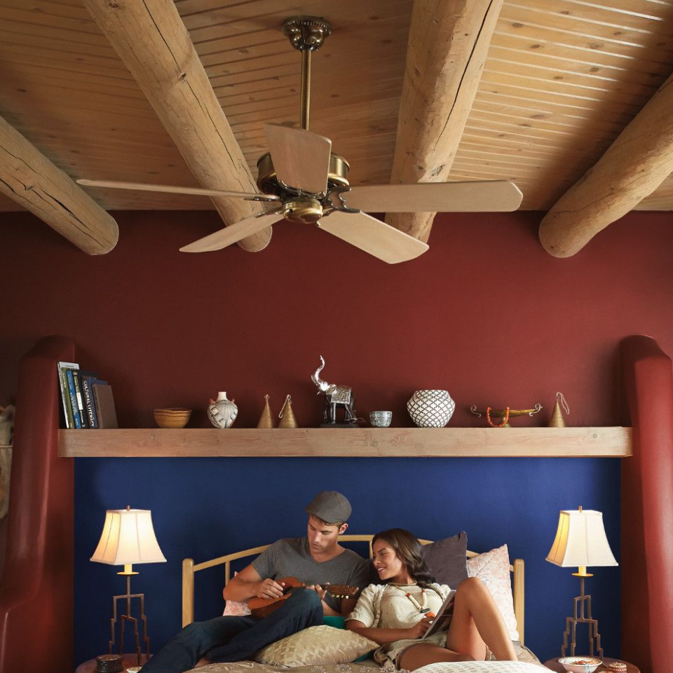 Wood-beamed ceiling bedroom. Walls painted red farmhouse.