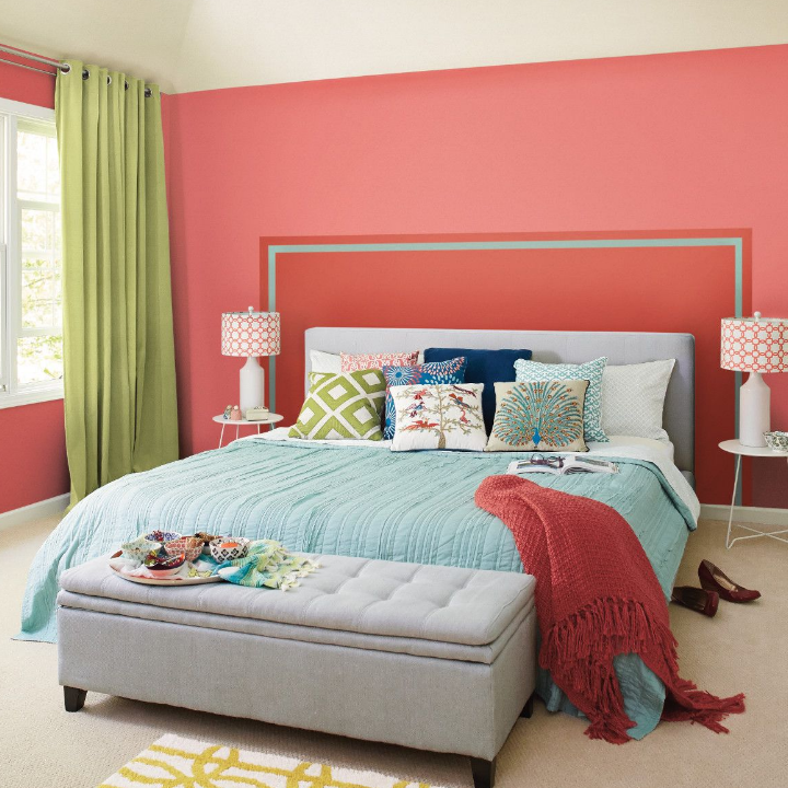 bright colored bedroom with bed, pillows and side table