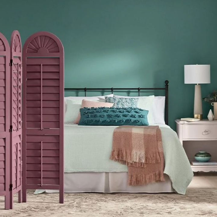 bedroom with bed, room divider and nightstand