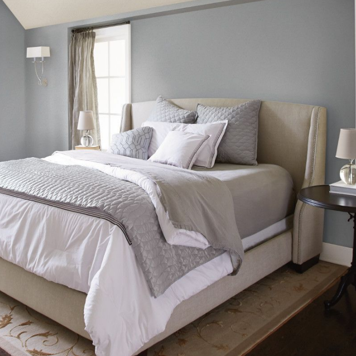 A calming bedroom, with ironed gray on the walls.